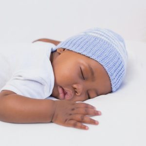 Adorable baby boy sleeping peacefully at home in the living room