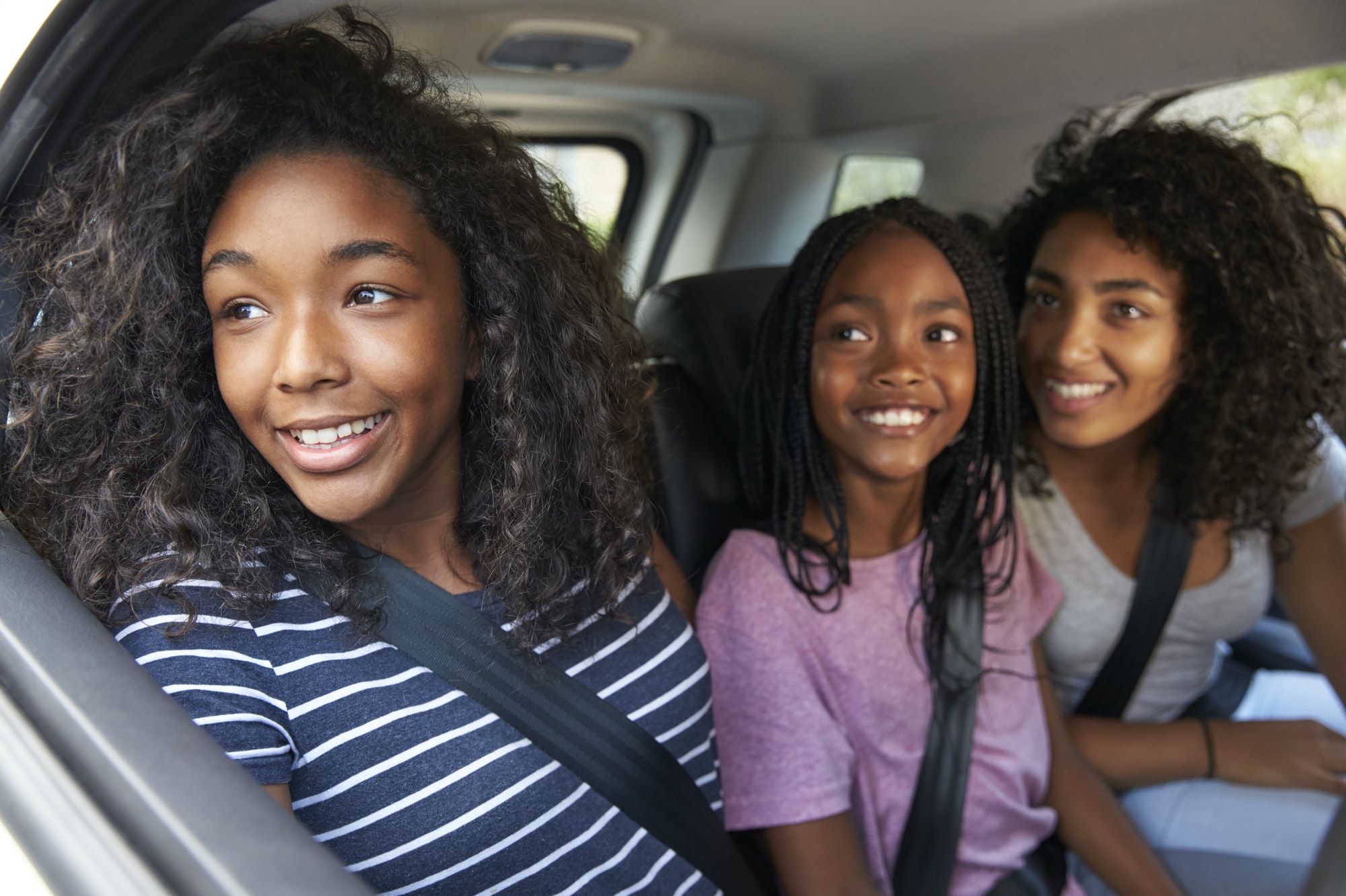 Family With Teenage Children In Car On Road Trip