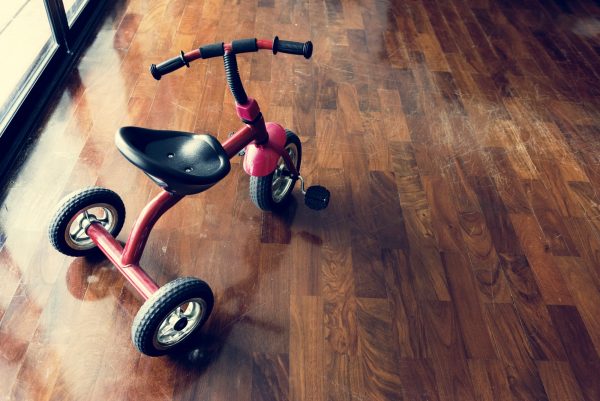 Kid bicycle on the wooden floor