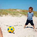 Little Kid Playing Football with Dad