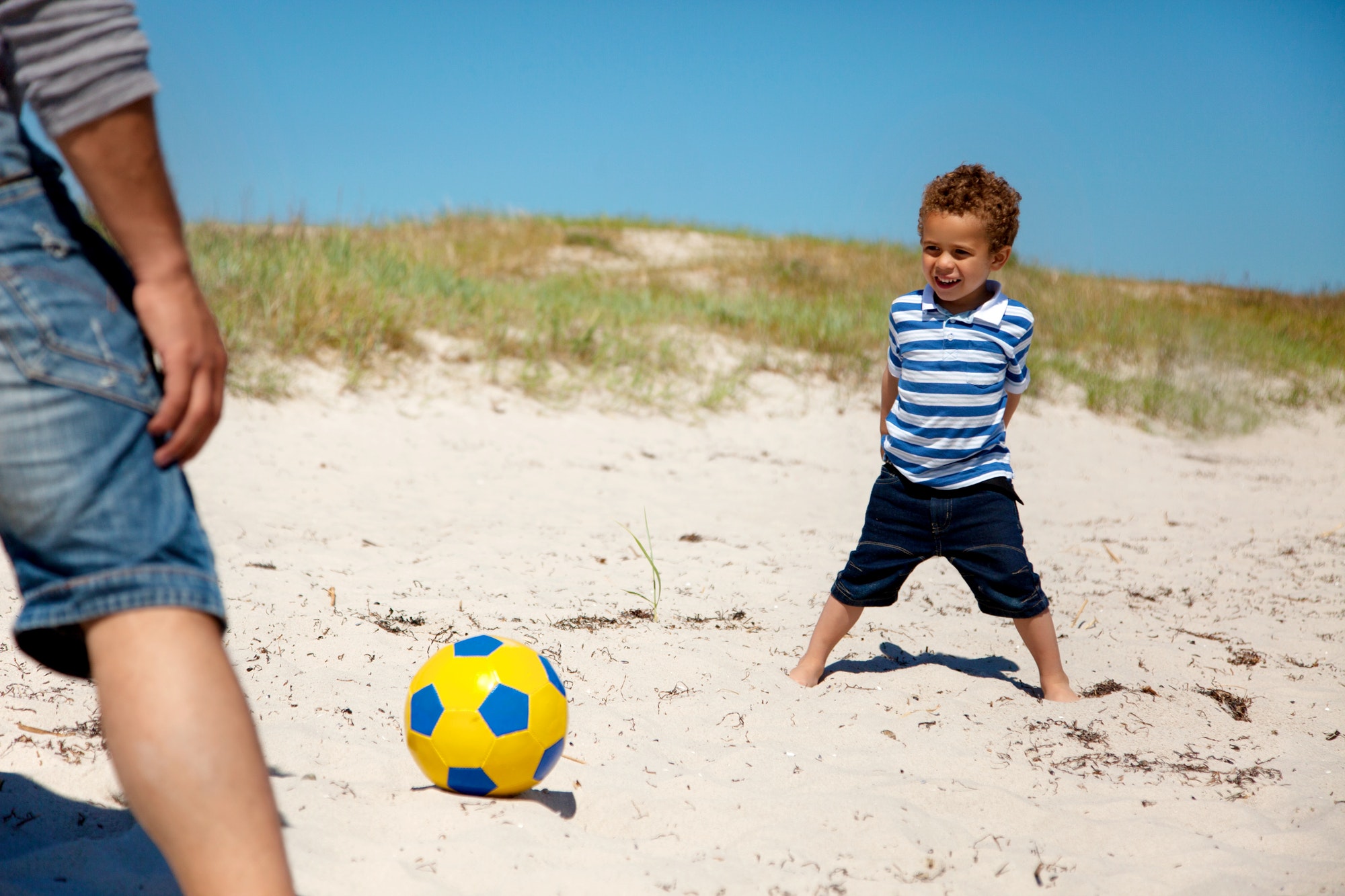 Little Kid Playing Football with Dad