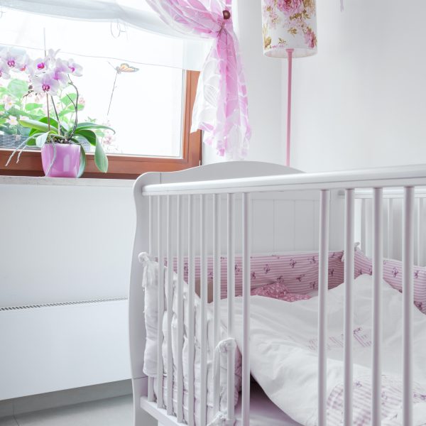 White crib in nursery room